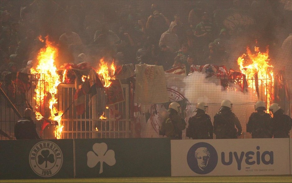 Fig: Fans set fire to the banners in the stands during a match between rivals Panathinaikos and Olympiacos in Greece.